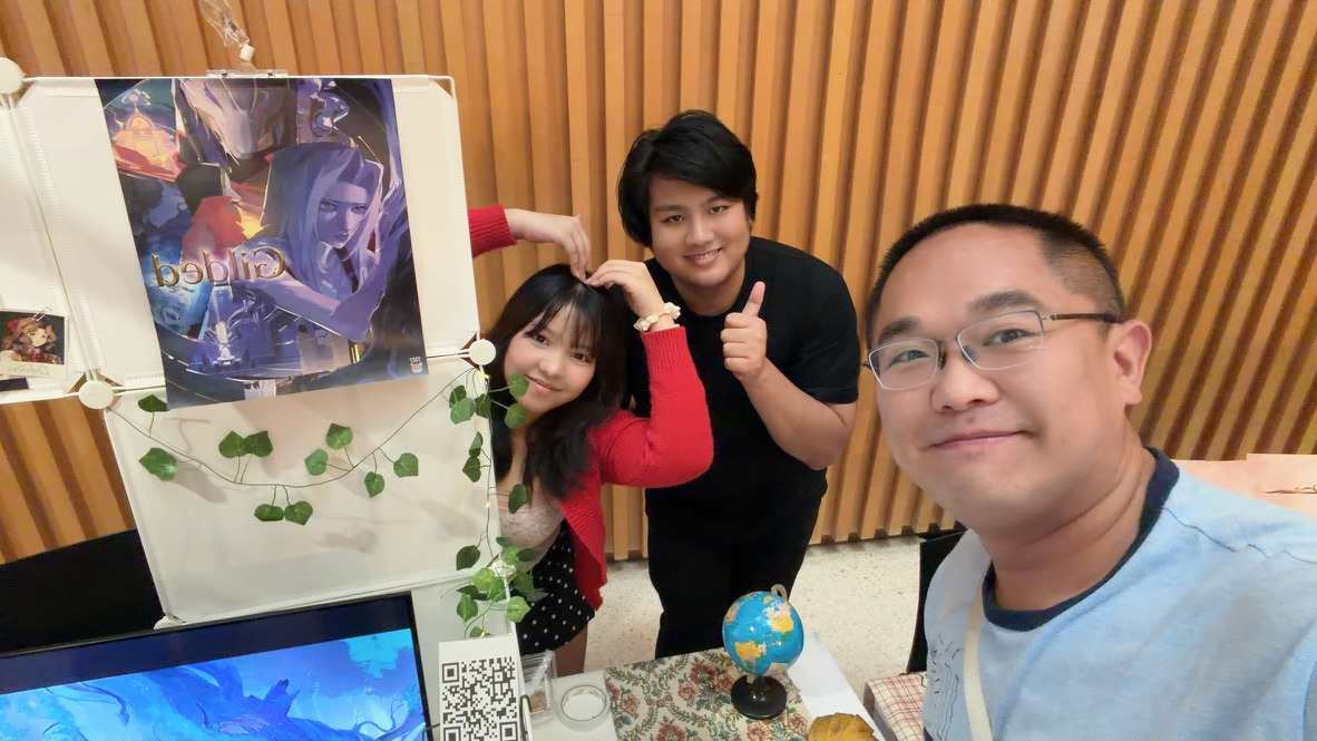 Terry posing with two artists beside their illustrated Glide display at a Bangkok creative market