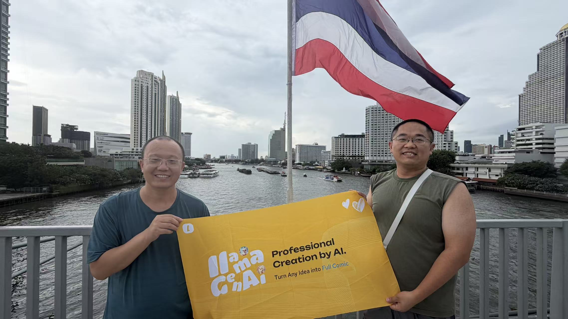 Terry and a friend holding a Professional Creation by AI banner beside the Chao Phraya River under the Thai flag